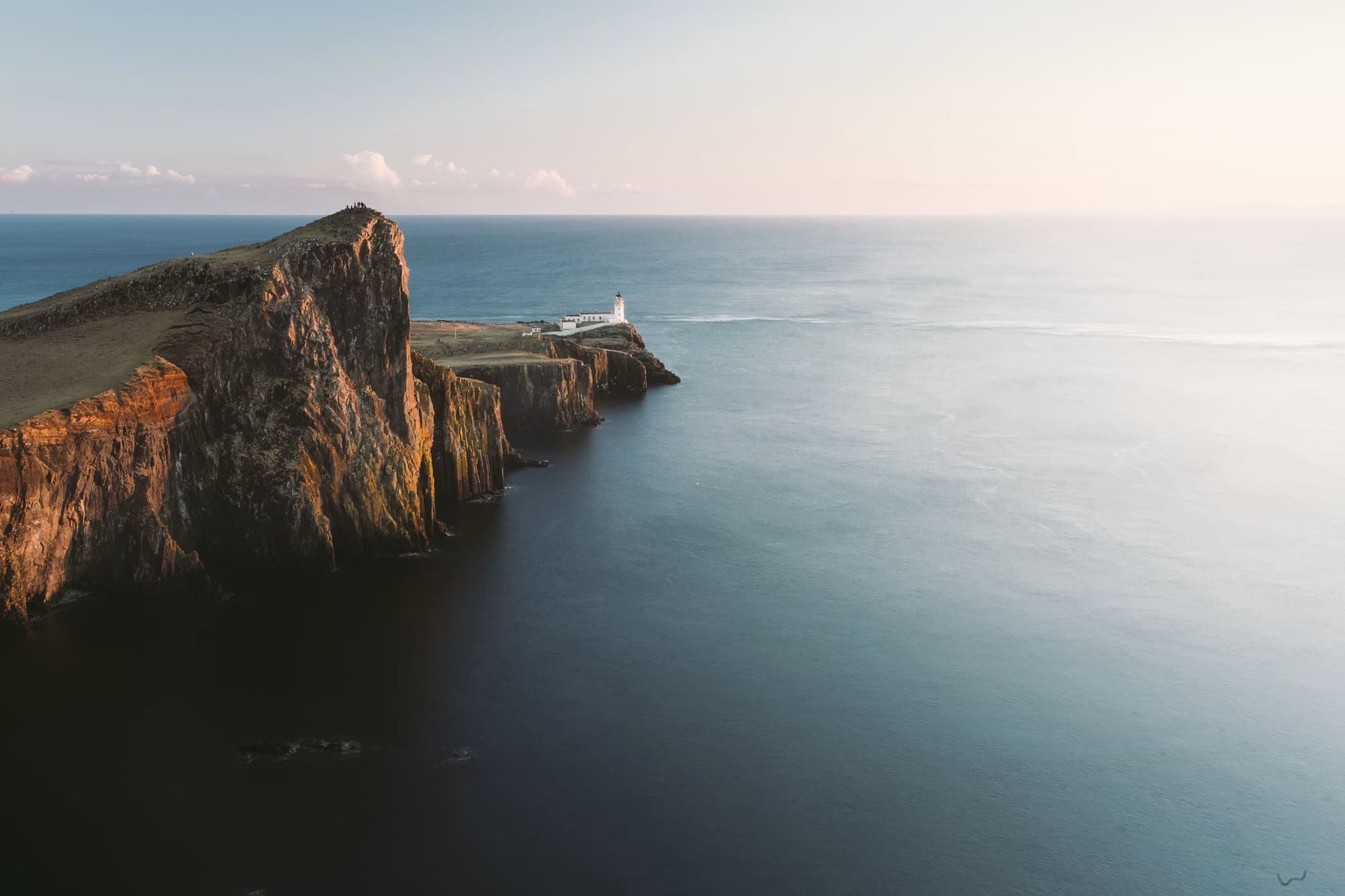 An aerial view of a dramatic coastal cliff