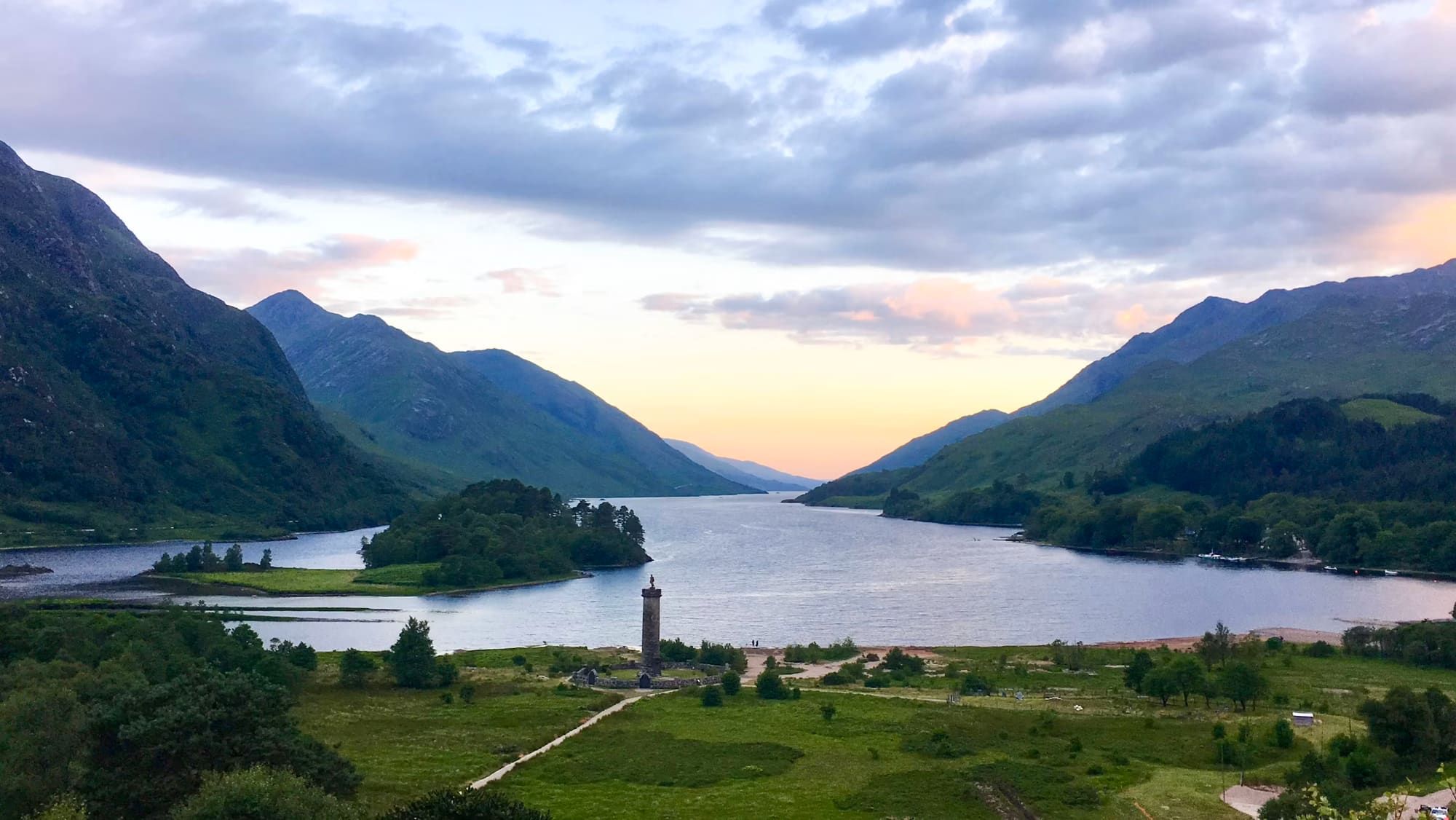 A quiet Highland loch overlooked by layered mountains